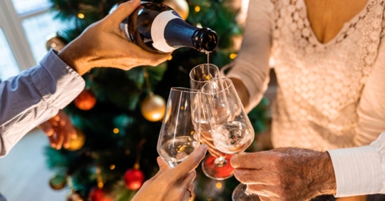 pouring wine at holiday party